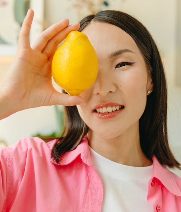 Woman feeling energetic and vibrant in a bright natural setting.